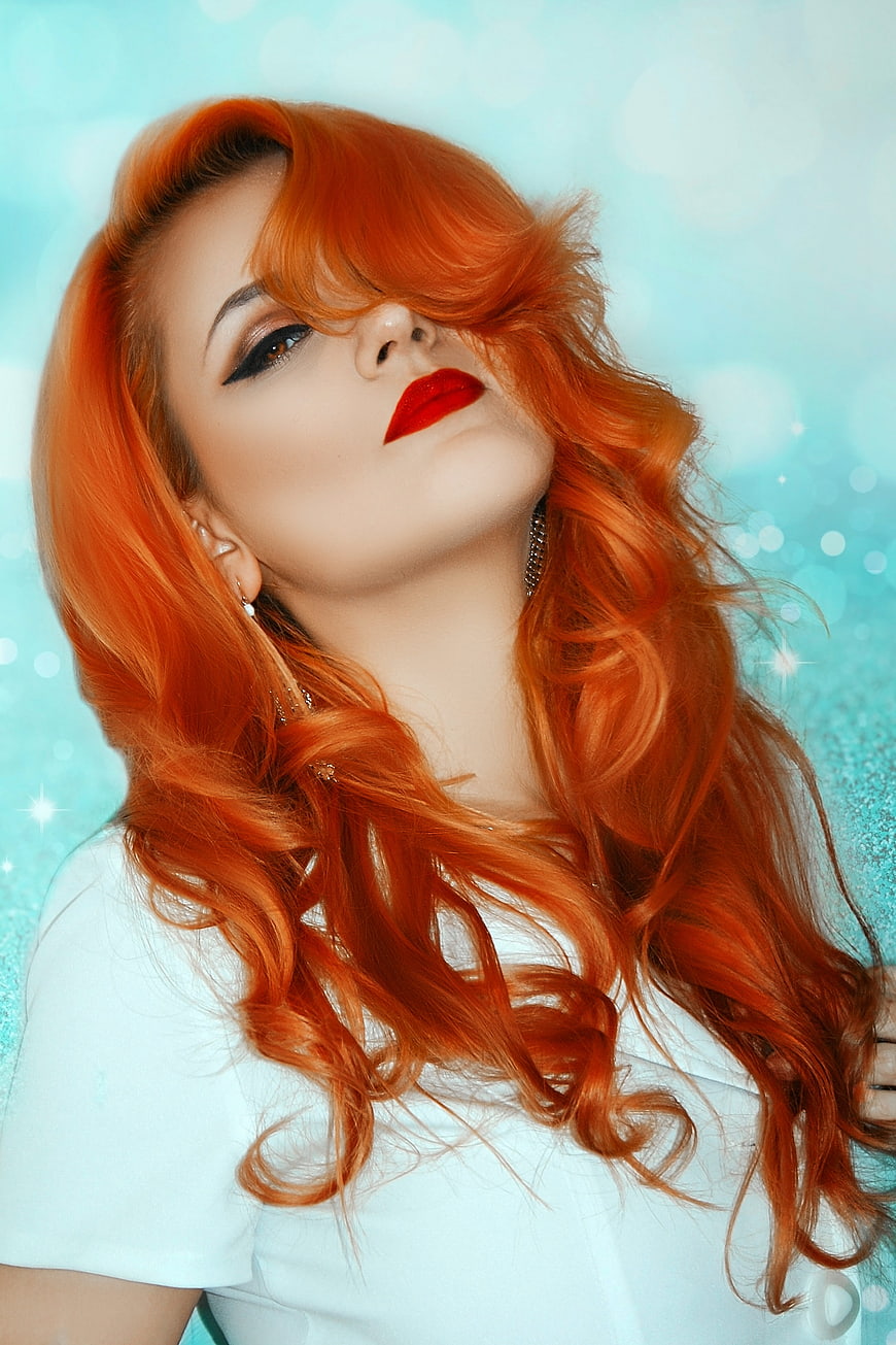 Stylish Portrait of Woman with Vibrant Orange Hair and Red Lips