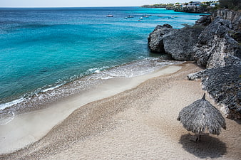 Secluded Caribbean Beach with Turquoise Water and Thatched Umbrella