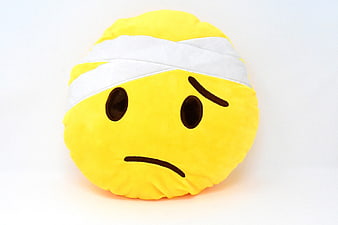Sad Bandaged Emoji Plush Pillow on White Background