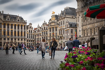 Grand Place Brussels with tourists and flowers