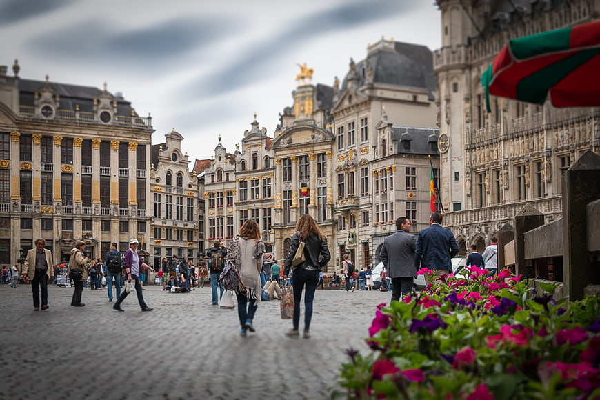 Grand Place Brussels with tourists and flowers