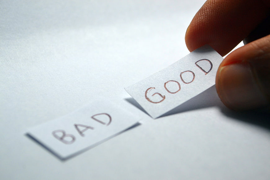 Hand choosing good over bad paper strips