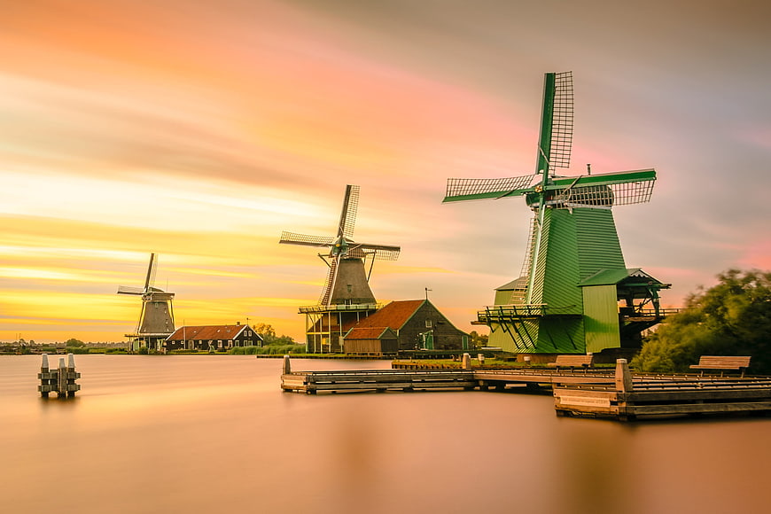 Dutch Windmills at Sunset Over Calm Water