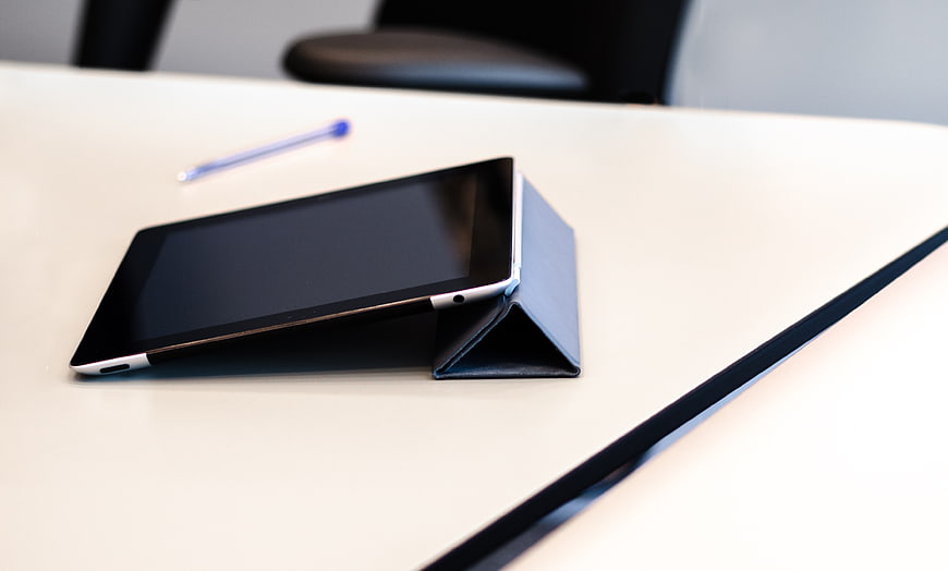 Tablet on white office desk with pen