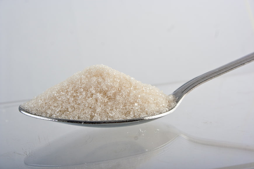Close-up of brown sugar on a silver spoon