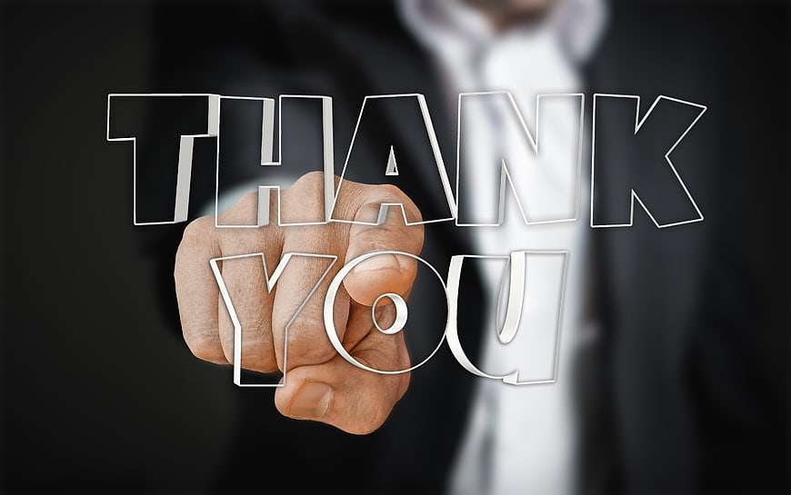 Businessman Hand Writing Thank You on Glass Screen
