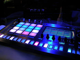 Pioneer DJ Controller With Glowing Blue And Pink Pads In Dark Studio