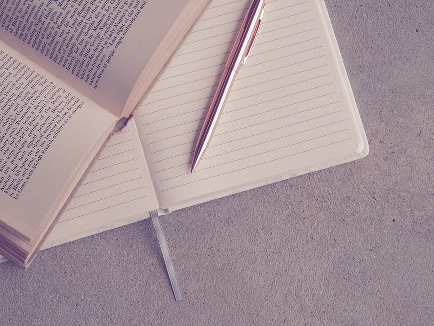Open Notebook with Rose Gold Pen and Vintage Book