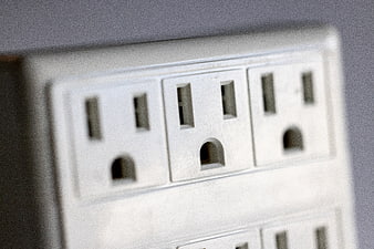 Close-up of white electrical power outlets on a wall
