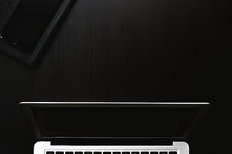 Minimalist Black Workspace with Laptop and Smartphone