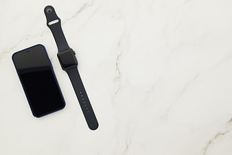Smartphone and Smartwatch on White Marble Surface