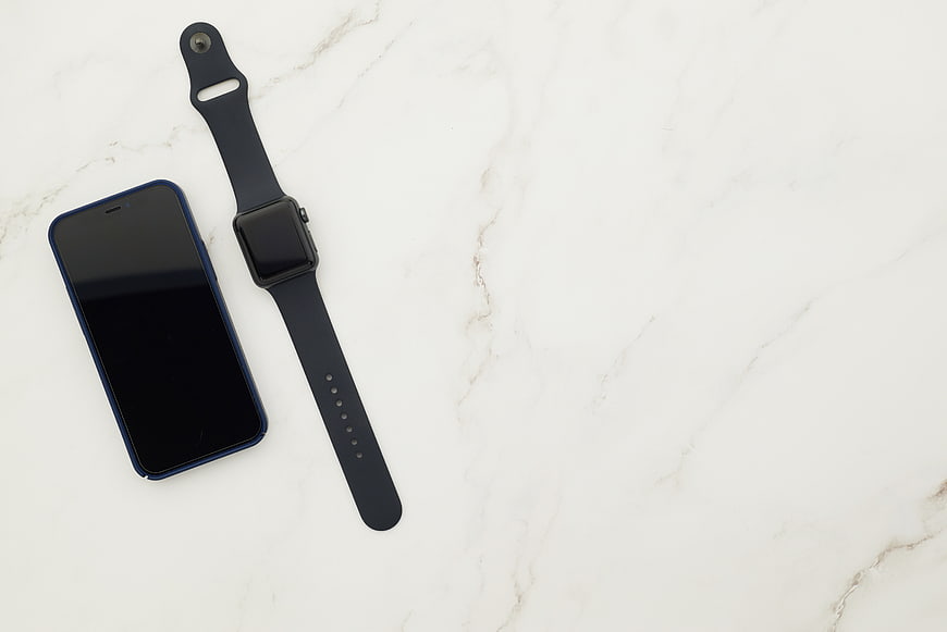 Smartphone and Smartwatch on White Marble Surface