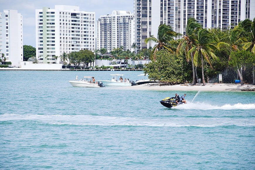 Jet Ski Riders on Turquoise Water with Miami Skyline
