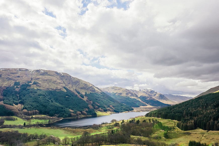 Scenic Highland Lake Valley with Snow-Capped Mountains