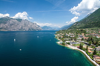 Aerial view of Lake Garda coastline with mountains and boats