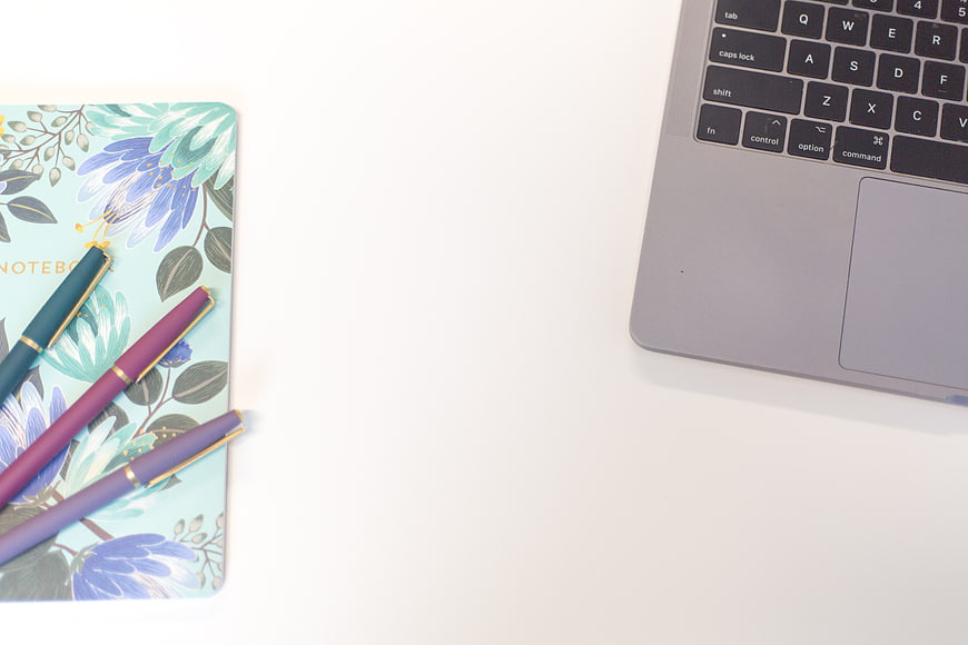 Minimalist Workspace with Floral Notebook and Laptop