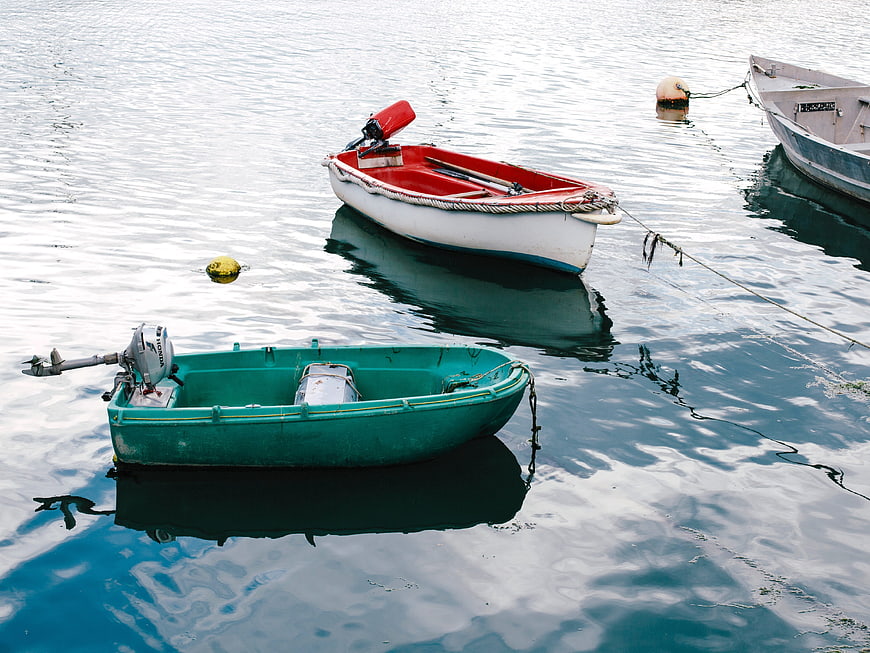Colorful small boats floating on calm blue water