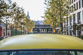 Yellow Taxi Roof Sign in Urban City Street