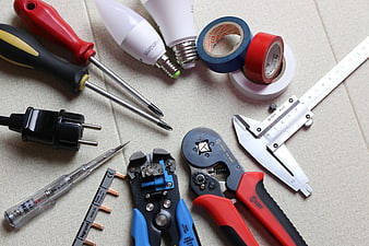 Assorted Electrical Tools And Hardware On Beige Fabric