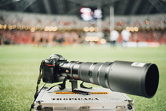 Professional Nikon Camera with Telephoto Lens on Sports Field