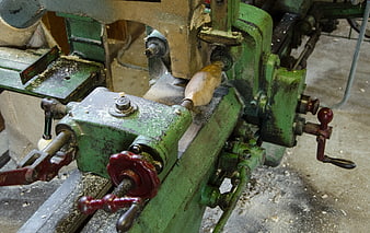 Vintage green woodturning machine shaping wooden clog