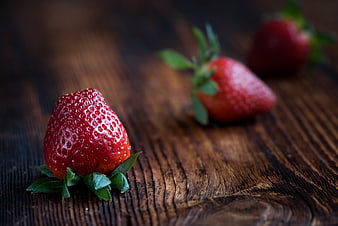 Fresh Ripe Strawberries on Dark Rustic Wooden Table