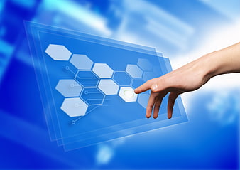 Hand touching futuristic digital interface with hexagon pattern