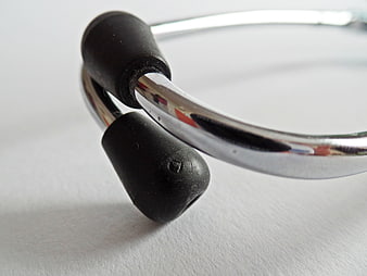 Close-up of a silver stethoscope with black earpieces on a white background