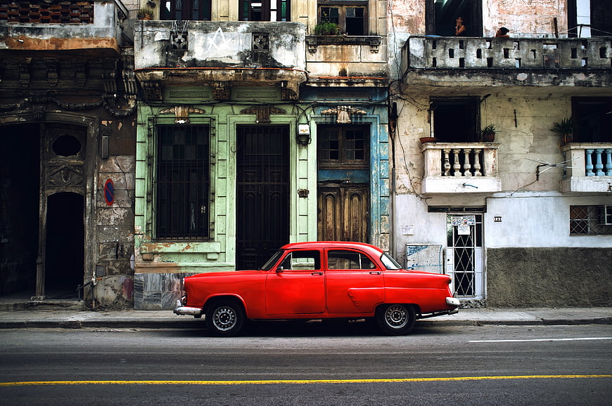 Vintage red classic car parked on street in Havana, Cuba