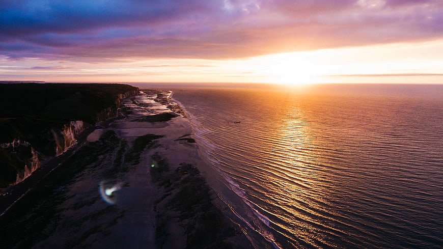 Aerial View of Dramatic Coastal Cliffs at Golden Sunset