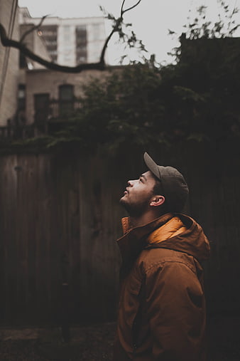 Man in Brown Jacket Looking Up Outdoors