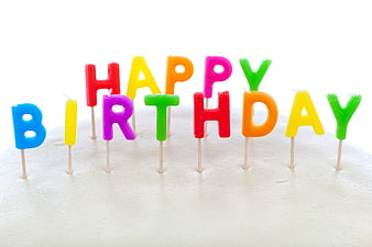 Colorful Happy Birthday Letter Candles on White Cake