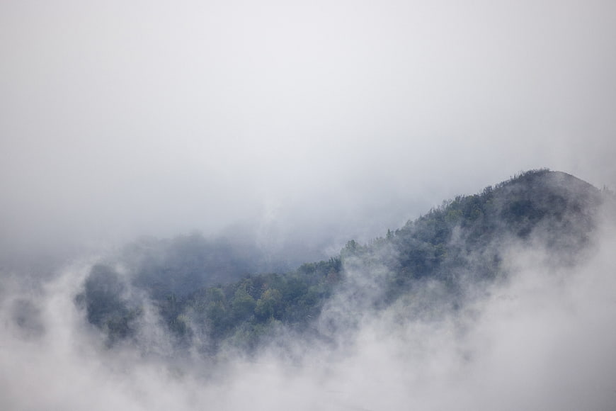 Misty Mountain Peak Emerging Through Thick Fog
