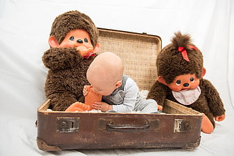 Baby in vintage suitcase with Munchkin dolls