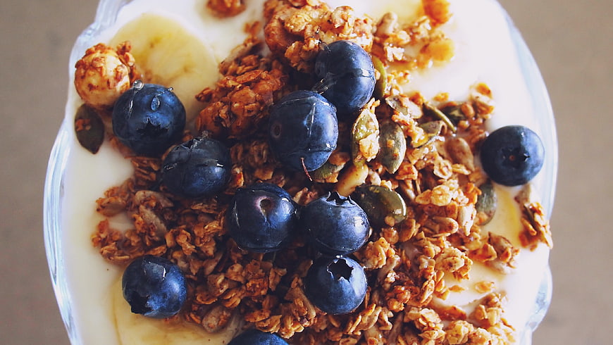 Overhead shot of yogurt bowl with granola and blueberries