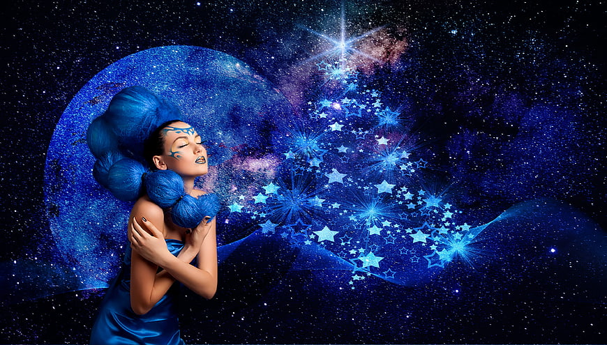 Fantasy woman with blue hair and galaxy makeup exhaling stars
