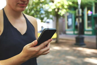 Woman Using Smartphone on City Street