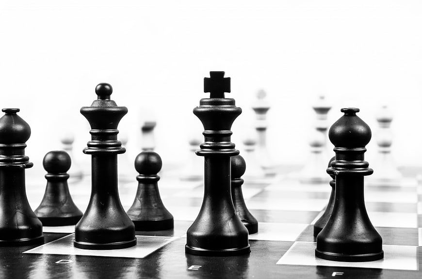 Black Chess Pieces on Board with White Background