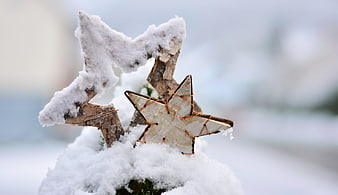 Snowy wooden stars on a Christmas tree top