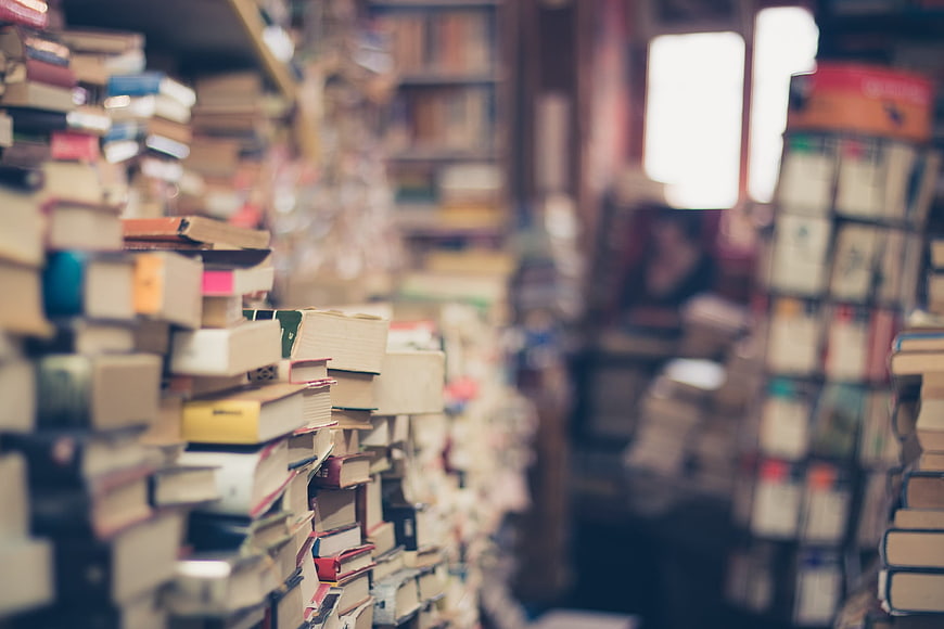 Stacks of vintage books in a cozy second-hand bookstore