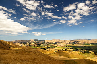 Rolling Tuscan Hills with Golden Grass and Blue Sky
