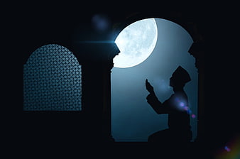 Silhouette of Muslim man praying under full moon in mosque archway