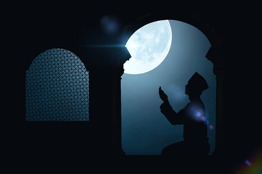 Silhouette of Muslim man praying under full moon in mosque archway