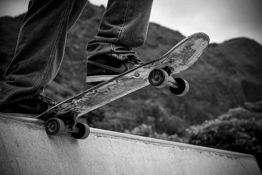 Skateboarder performing trick on concrete ramp