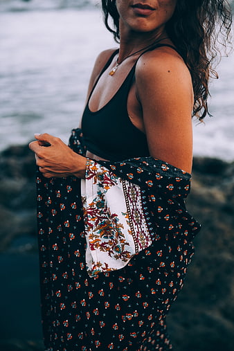 Woman in Floral Dress by the Ocean Shore
