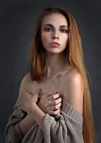 Studio Portrait of Young Woman in Off-Shoulder Knit Sweater