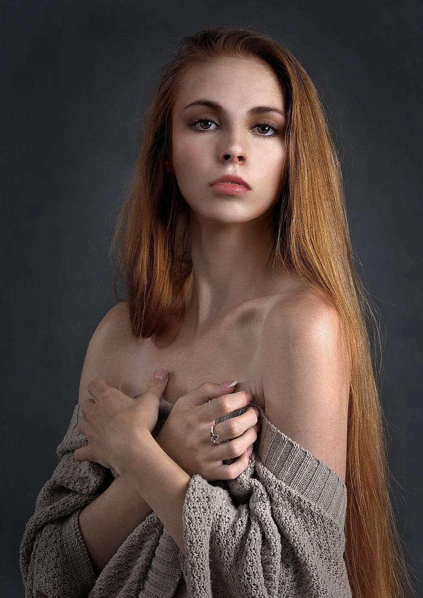 Studio Portrait of Young Woman in Off-Shoulder Knit Sweater