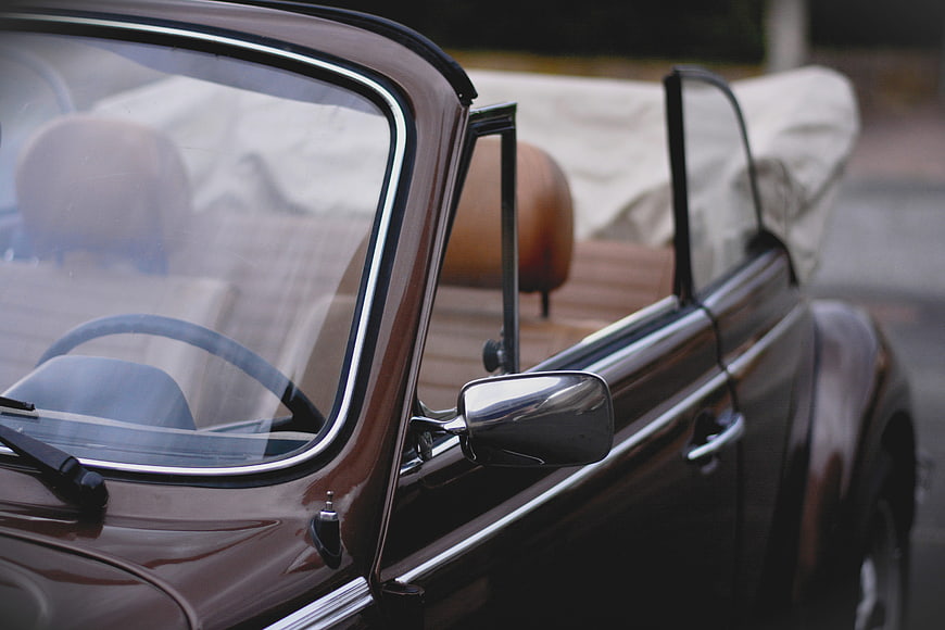 Close-up of a classic brown VW Beetle convertible with chrome details