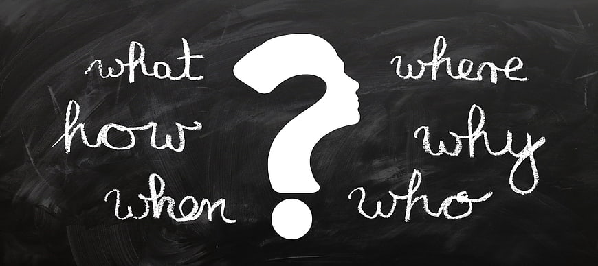 Question mark silhouette with what, where, how, why, when, who on blackboard