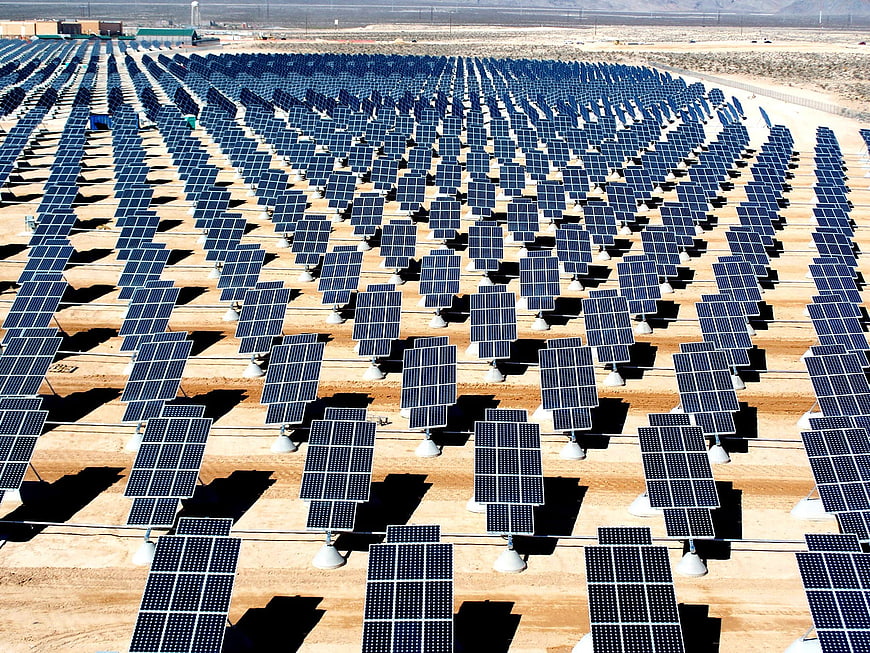 Aerial View of Large Solar Panel Array in Desert Landscape